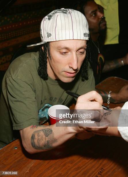 Sevendust drummer Morgan Rose signs a fan's arm after a concert at the House of Blues inside the Mandalay Bay Resort & Casino April 4, 2007 in Las...