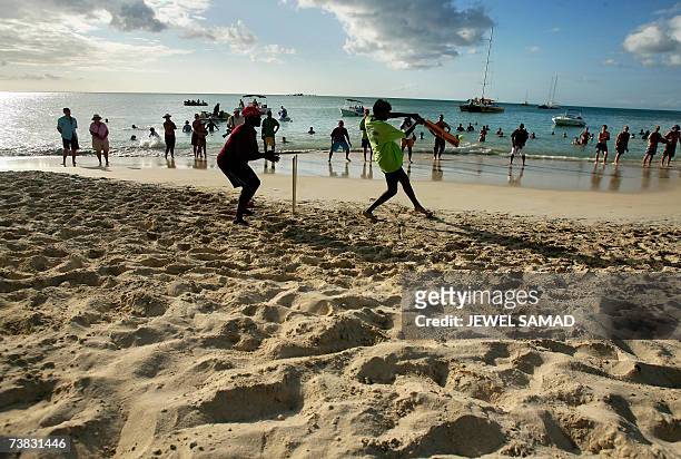 St John's, ANTIGUA AND BARBUDA: A batsman plays a shot during a beach cricket game between Antigua Legends and the visiting international media...