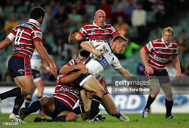 Brent Tate of the Brisbane Broncos is tackled by the Sydney Roosters during the round four NRL match between the Sydney Roosters and the Brisbane...