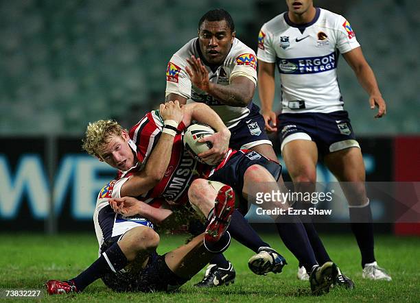 Joel Monaghan of the Sydney Roosters is group tackled by the Brisbane Broncos during the round four NRL match between the Sydney Roosters and the...
