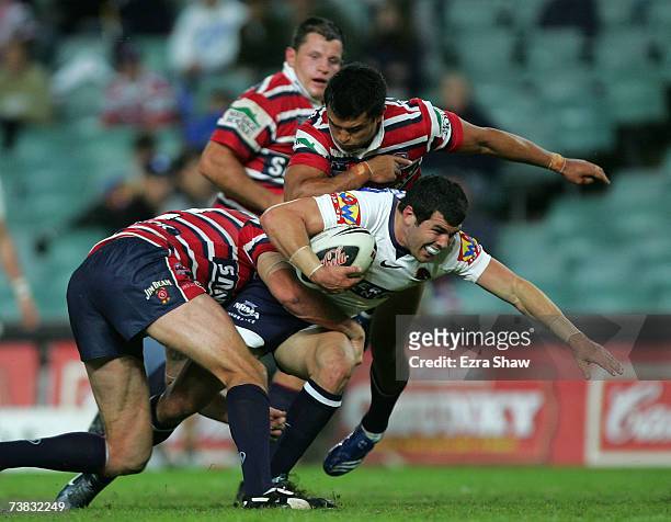 Michael Ennis of the Brisbane Broncos is tackled by the Sydney Roosters during the round four NRL match between the Sydney Roosters and the Brisbane...