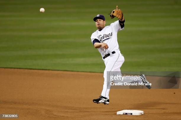 Second baseman Marcus Giles of the San Diego Padres throws the ball to first in the fourth inning against the Colorado Rockies during Opening Night...
