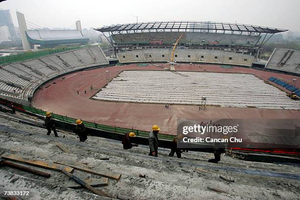 Chinese labourers work at the construction site of the Olympic Sports Center Stadium on the Olympic Green on March 30, 2007 in Beijing, China. The...