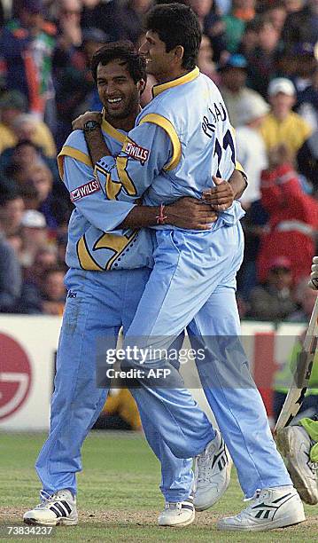 Manchester, UNITED KINGDOM: In this file picture taken, 08 June 1999, Indian cricketers Robin Singh and teammate BK Venkatesh Prasad celebrate one of...