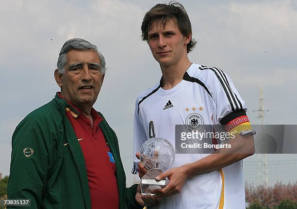 Captain Benedikt Howedes receives the trophy for the winning team during the Men's U19 international friendly match between Portugal and Germany on...