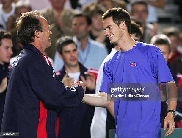 Captain John Lloyd of Great Britain shakes hands with Andy Murray after Great Britain's victory in the doubles and overall tie during the Davis Cup...