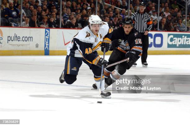 Daniel Briere of the Buffalo Sabres skates with the puck against Boyd Gordon of the Washington Capitals during their NHL hockey game at the Verizon...