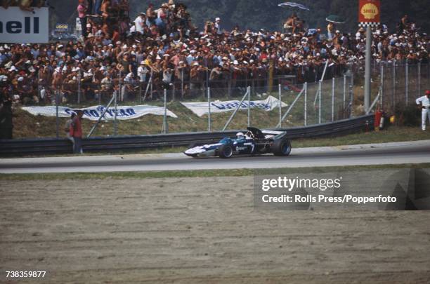 British racing driver John Surtees drives the Brooke Bond Oxo Team Surtees Surtees TS9 Ford Cosworth DFV 3.0 V8 in the 1971 Italian Grand Prix at...