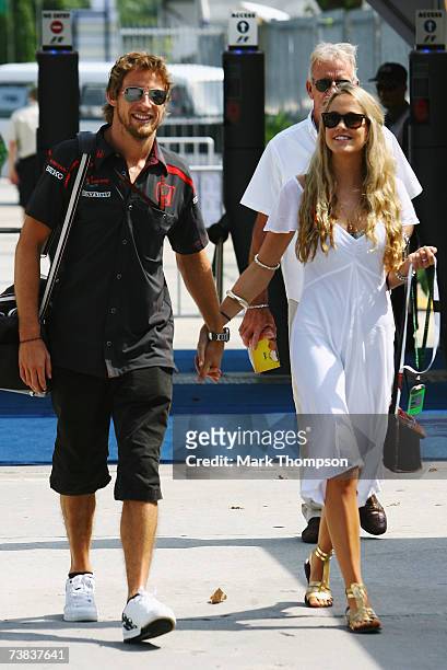 Jenson Button of Great Britain and Honda Racing and his girlfriend Florence Brudenell-Bruce, walk in the paddock during the Malaysian Formula One...