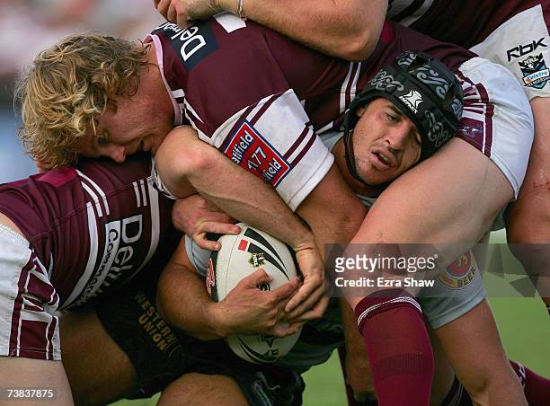 Tony Martin of the Warriors is tackled by Luke Williamson and a group of the Sea Eagles defence during the round four NRL match between the Manly...