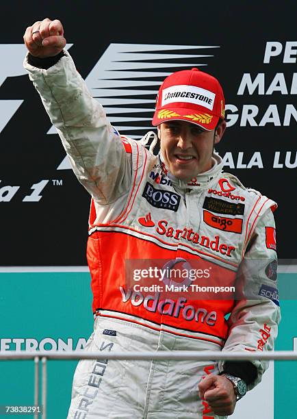 Fernando Alonso of Spain and McLaren Mercedes celebrates following his first place in the Malaysian Formula One Grand Prix at the Sepang Circuit on...