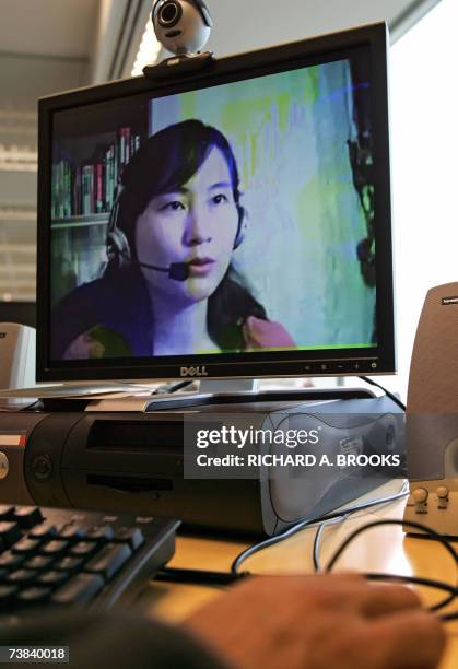 By GUY NEWEY - FILES - This picture shows a computer user in Hong Kong, 27 March 2007, looking at an image of online Mandarin teacher Lily Huang at...