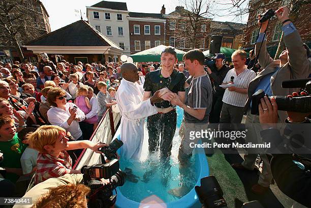 Archbishop of York Dr John Sentamu baptises a local church goer in a water tank during an Easter ceremony on April 8, 2007 in York city centre,...