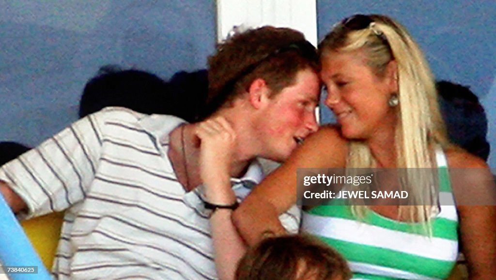 Britain's Prince Harry (L) enjoys a mome...