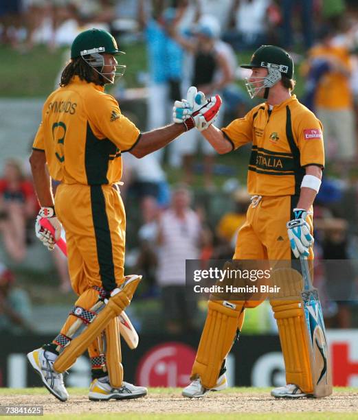 Michael Clarke of Australia celebrates victory with team mate Andrew Symonds during the ICC Cricket World Cup Super Eights match between Australia...