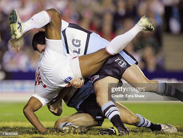 Wes Naiqama of the Dragons is turned upside down by the Sharks defence during the round four NRL match between the Cronulla Sharks and the St George...