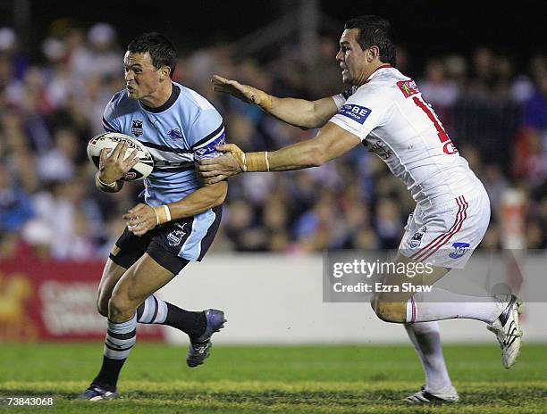 Fraser Anderson of the Sharks tries to escape the grasp of Jason Ryles of the Dragons during the round four NRL match between the Cronulla Sharks and...