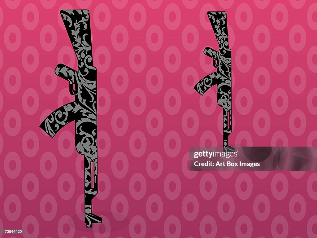 Close-up of two rifles on a pink background
