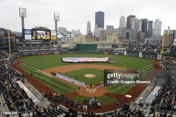 The Pittsburgh Pirates and St. Louis Cardinals line up for the National Anthem prior to the Pirates' Home Opener April 9, 2007 at PNC Park in...