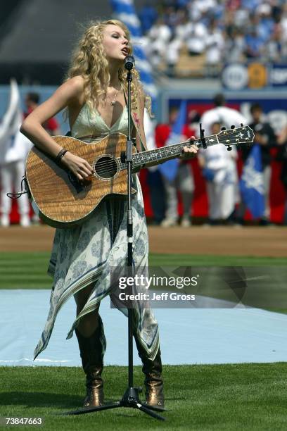 Country singer Taylor Swift sings the national anthem before the game between the Los Angeles Dodgers and the Colorado Rockies on opening day at...