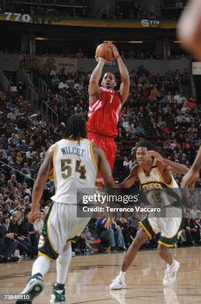 Tracy McGrady of the Houston Rockets shoots over the defense of Chris Wilcox and Mickael Gelabale of the Seattle SuperSonics on April 9 , 2007 at the...
