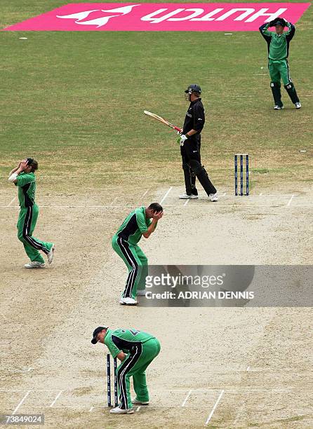 Irish players react to missing a run-out opportunity against New Zealand during the Super-Eight match at Guyana National Stadium in Georgetown,...