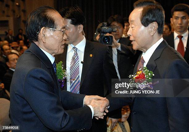 Hwang Jang-Yop , the highest-ranking defector ever to come to the South, shakes hands with former president Kim Young-Sam during a founding ceremony...