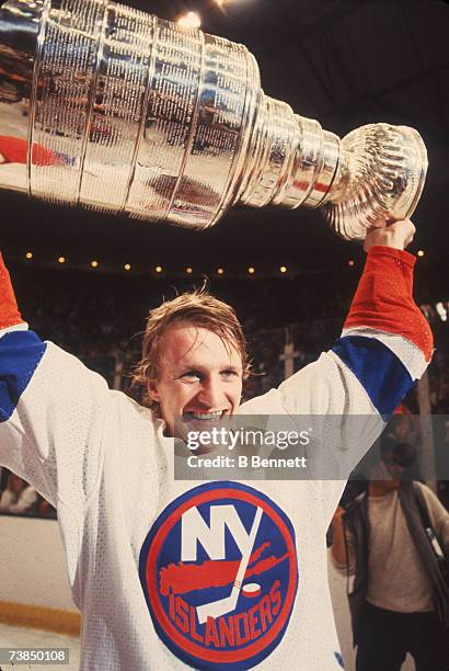 Swedish professional ice hockey player Tomas Jonsson of the New York Islanders raises the Stanley Cup trophy over his head in celebration after his...