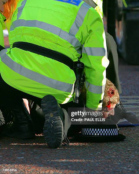 Manchester, UNITED KINGDOM: Police officers arrest a Roma's fan as Manchester United's fans clashed with AS Roma's before their European Champions...