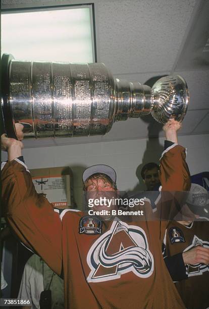 Swedish professional ice hockey player Peter Forsberg of the Pittsburgh Penguins hoists the Stanley Cup trophy over his head in celebration of his...