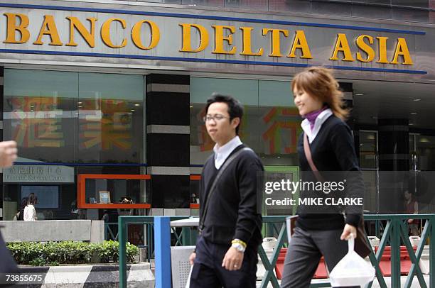 The picture taken 14 March 2007 shows pedestrians walking past a branch of Banco Delta Asia in Macau. The US State Department said late 10 April 2007...