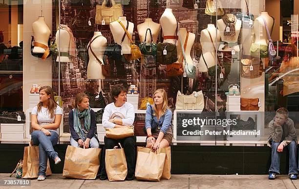 Shoppers rest after a visit to the newly opened Primark clothing store on Oxford Street on April 11, 2007 in London, England. Police were called on...