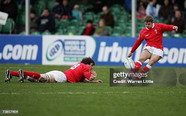 Leight Halfpenny of Wales converts a kicks at goal as Captain Sam Warburton keeps the ball on the tee during the IRB U-19 Rugby World Cup match...