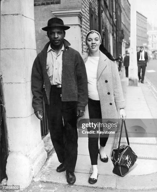 Maj-Britt Morrison leaves the West London Police Court with her husband Raymond, having been charged with obstruction during the Notting Hill race...