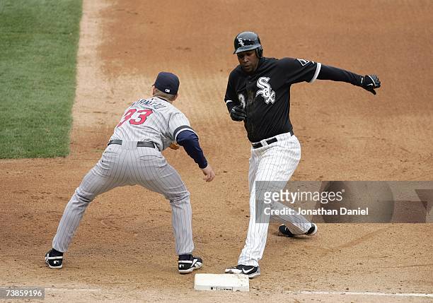 Justin Morneau of the Minnesota Twins tries to tag out Jermaine Day of the Chicago White Sox on April 7, 2007 at U.S. Cellular Field in Chicago,...
