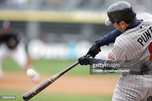 Nick Punto of the Minnesota Twins connects with the pitch during the game against the Chicago White Sox on April 7, 2007 at U.S. Cellular Field in...