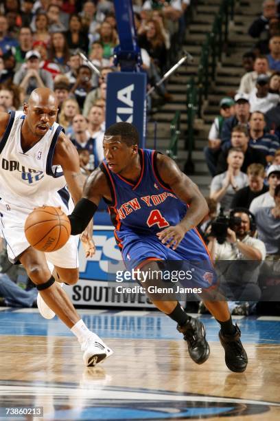 Nate Robinson of the New York Knicks pushes the ball upcourt against the Jerry Stackhouse of the Dallas Mavericks during the game at American...