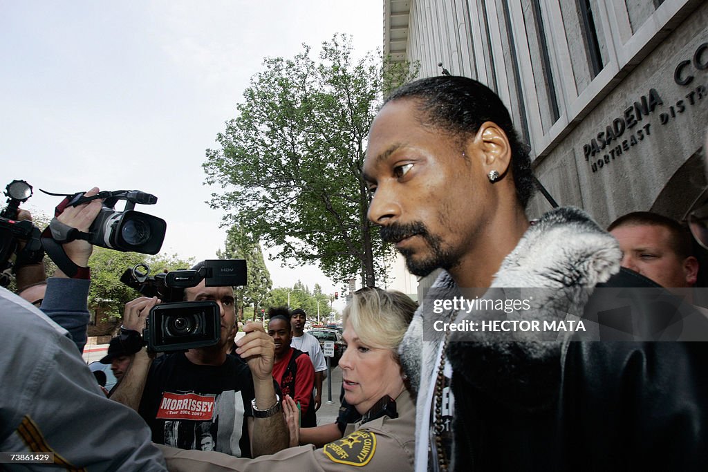 Rap singer Snoop Dogg (R) leaves the Pas...