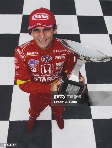 Alex Zanardi of Italy, driver of the Target Ganassi Racing Reynard 98i Honda poses for a portrait holding his PPG Industries Championship Trophy...