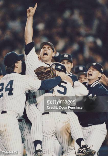 Pitcher and closer John Wetteland of the New York Yankees celebrates with his team mates after winning Game Six of the Major League Baseball World...