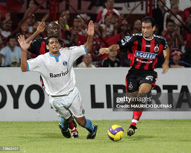 Diego Souza of Brasil's Gremio is fouled by Jose Castillo of Colombia's Cucuta Deportivo during their Libertadores Cup football match, 11 April in...