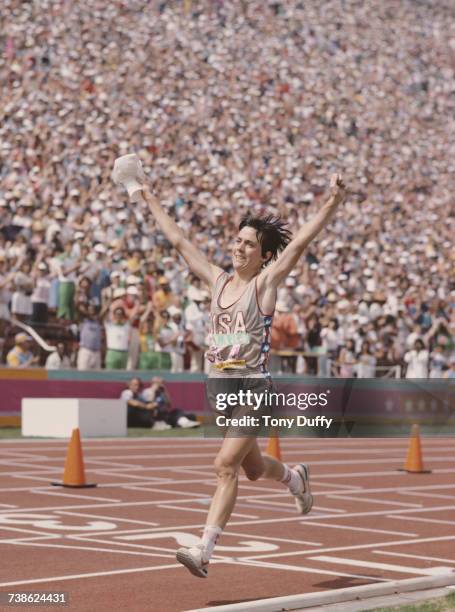 Joan Benoit of the United States raises her arms in celebration after winning the first ever Olympic Women's marathon event at the XXIII Olympic...