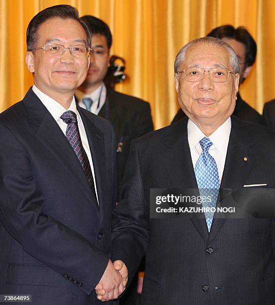 Visiting Chinese Prime Minister Wen Jiabao shakes hands with Daisaku Ikeda, President of the Soka Gakkai International, a lay Buddhist organization...