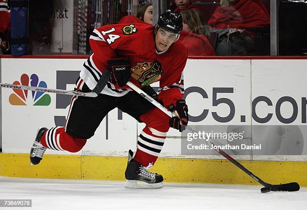 Rene Bourque of the Chicago Blackhawks skates with the puck against the Calgary Flames on March 25, 2007 at the United Center in Chicago, Illinois....