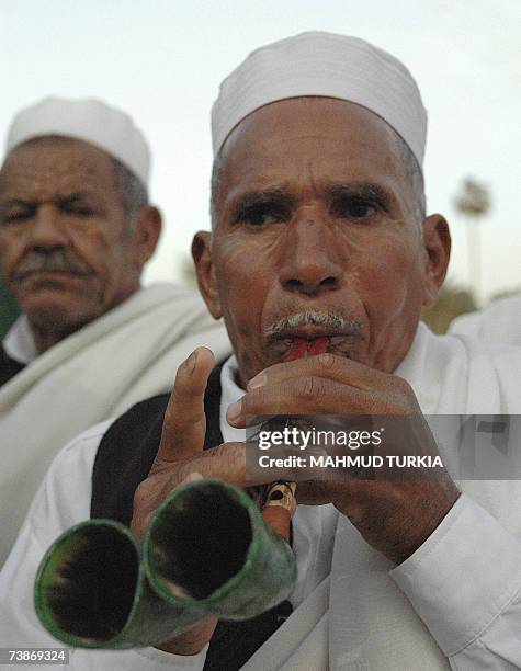 Tripoli, LIBYAN ARAB JAMAHIRIYA: A Libyan man plays a traditional musical instruments during celebrations to mark the Libyan capital Triploi as the...