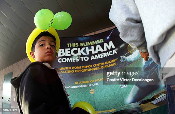 Young Los Angeles Galaxy fan Justin looks on as his father looks into premium seat prices prior to the MLS match between the Los Angeles Galaxy and...