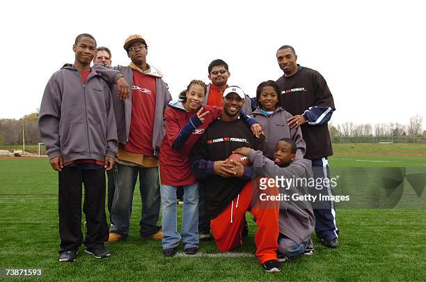 Duane Starks and Michael Lewis pose with a group of Special Olympics athletes at the "Special Olympics Rookie Training Camp" as part of the...