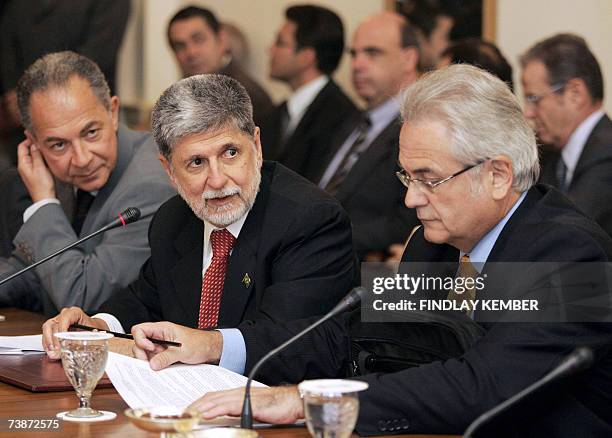 Brazilian Foreign Minister Celso Amorim speaks with delegation officials prior to a meeting with unseen India's Minister of State for External...