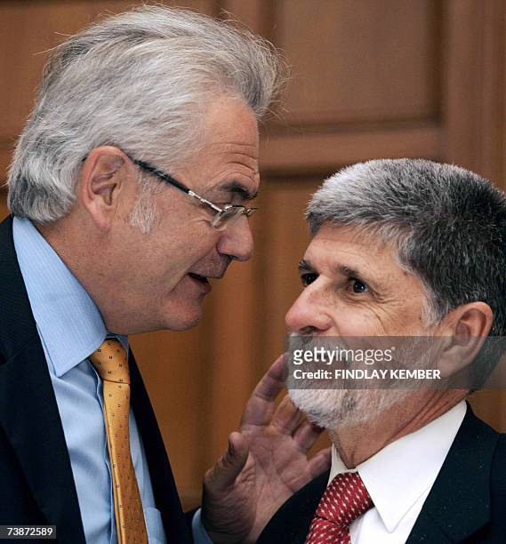 Brazilian Foreign Minister Celso Amorim speaks with a delegation official after a meeting with unseen Indian Minister of State for External Affairs...