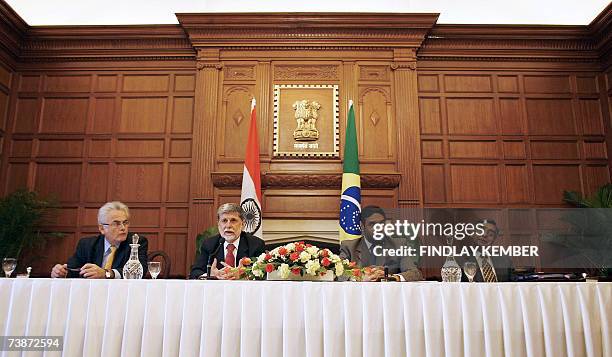 Brazilian Foreign Minister Celso Amorim and India's Minister of State for External Affairs Anand Sharma are flanked by officials as they address...